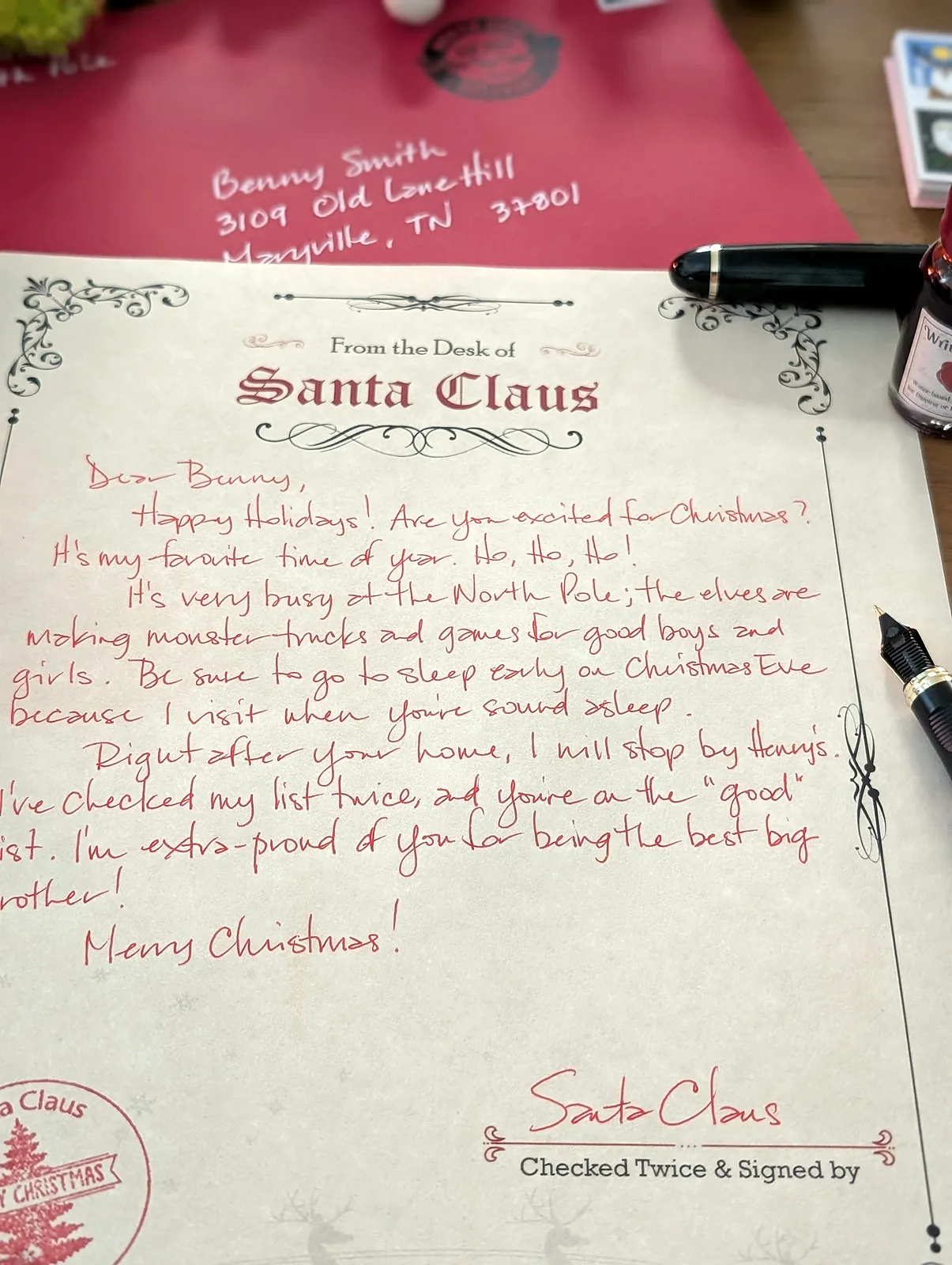 A full letter from Santa handwritten in red ink on cream Santa Claus letterhead, signed Santa Claus above the words Checked Twice and Signed
