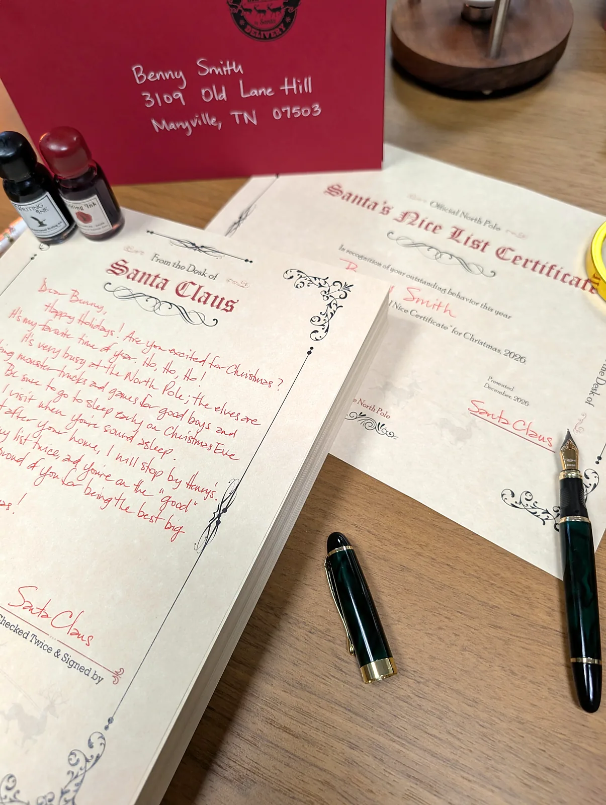 Santa's Nice List Certificate beside a handwritten letter from Santa and a red envelope hand-addressed in white ink