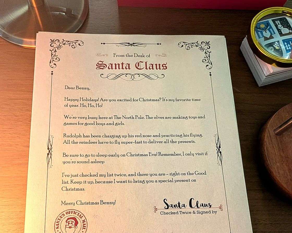 A free letter from Santa on cream parchment with its red envelope